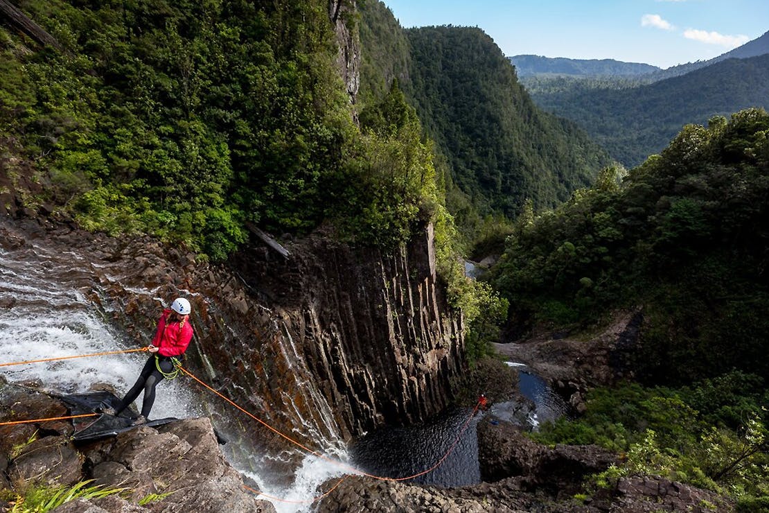 A girl hanging over a deep canyon